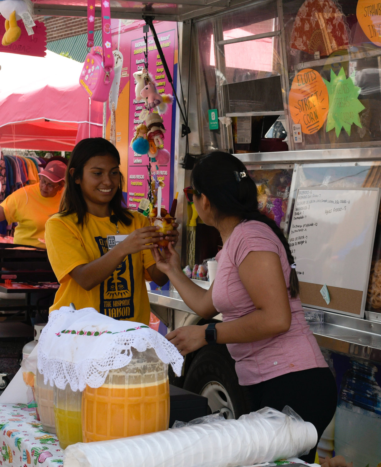 Attendees smile at the sweet treats stand at the Hispanic Heritage Festival in downtown Siler City Saturday.